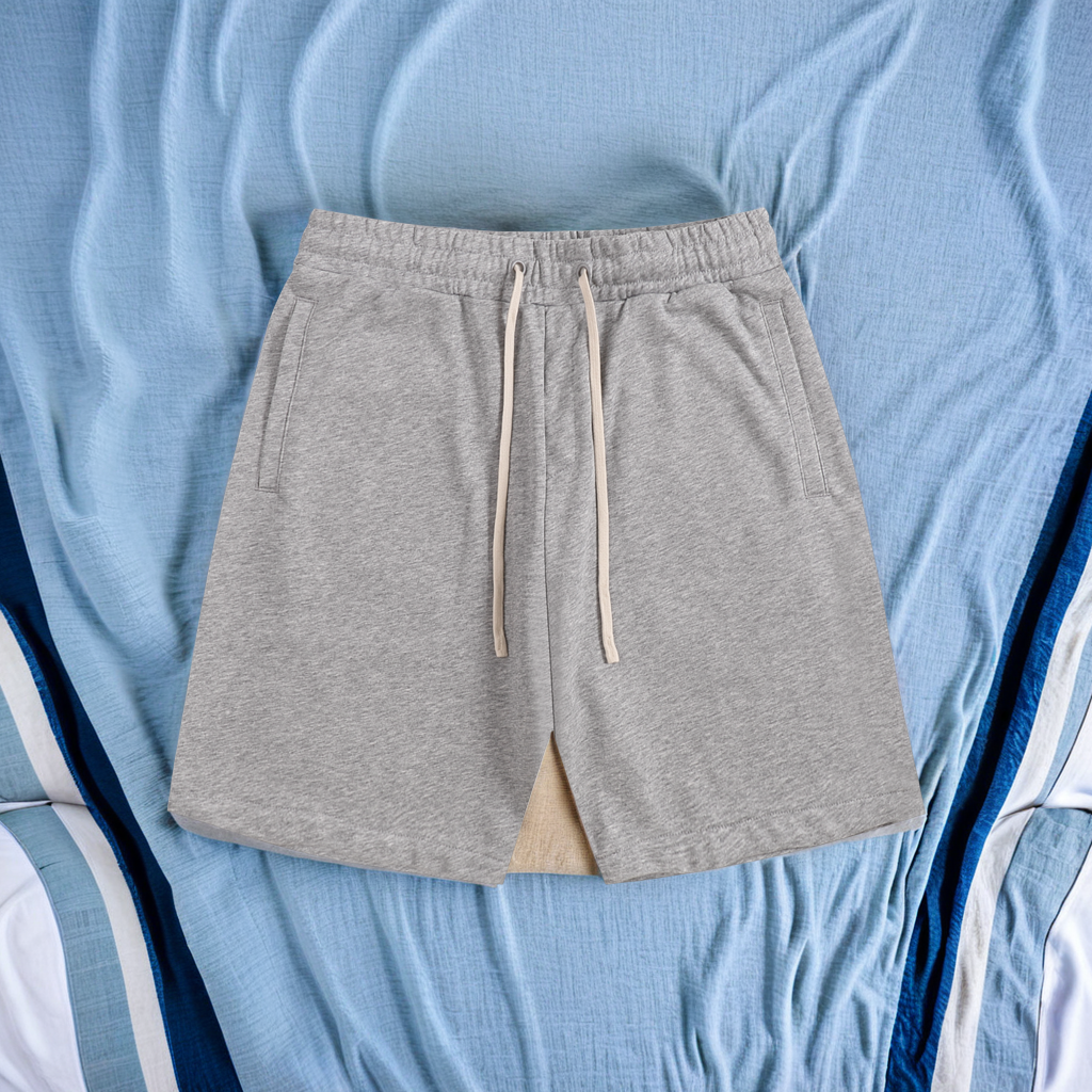Gray shorts with a drawstring on a blue fabric background