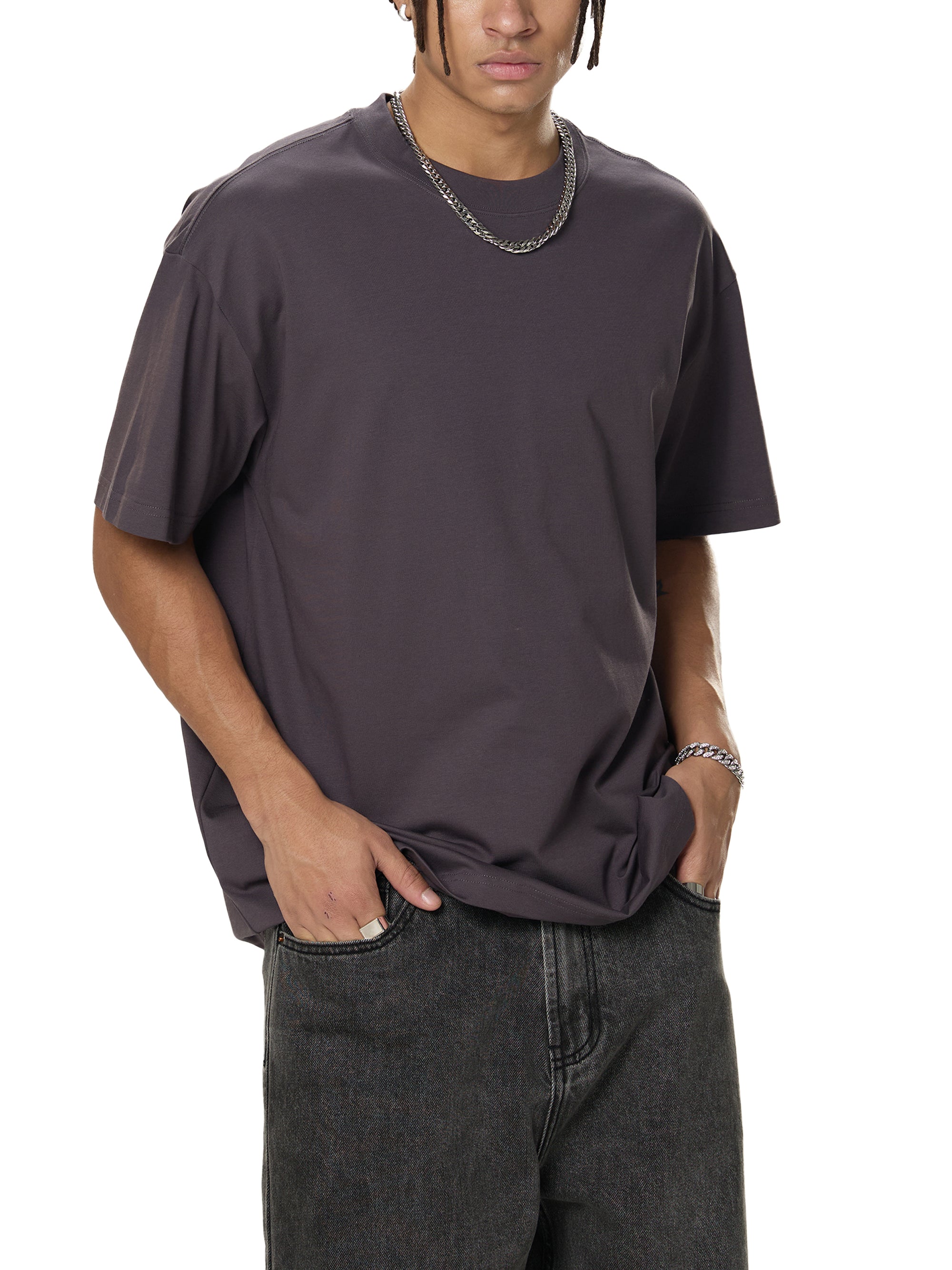 Person wearing a dark gray t-shirt and jeans on a white background
