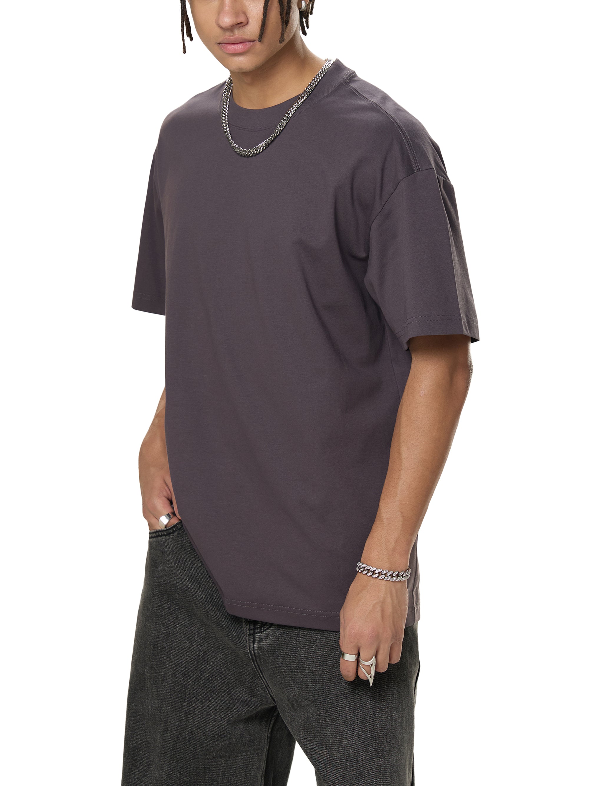 Person wearing a dark gray t-shirt and jeans on a white background