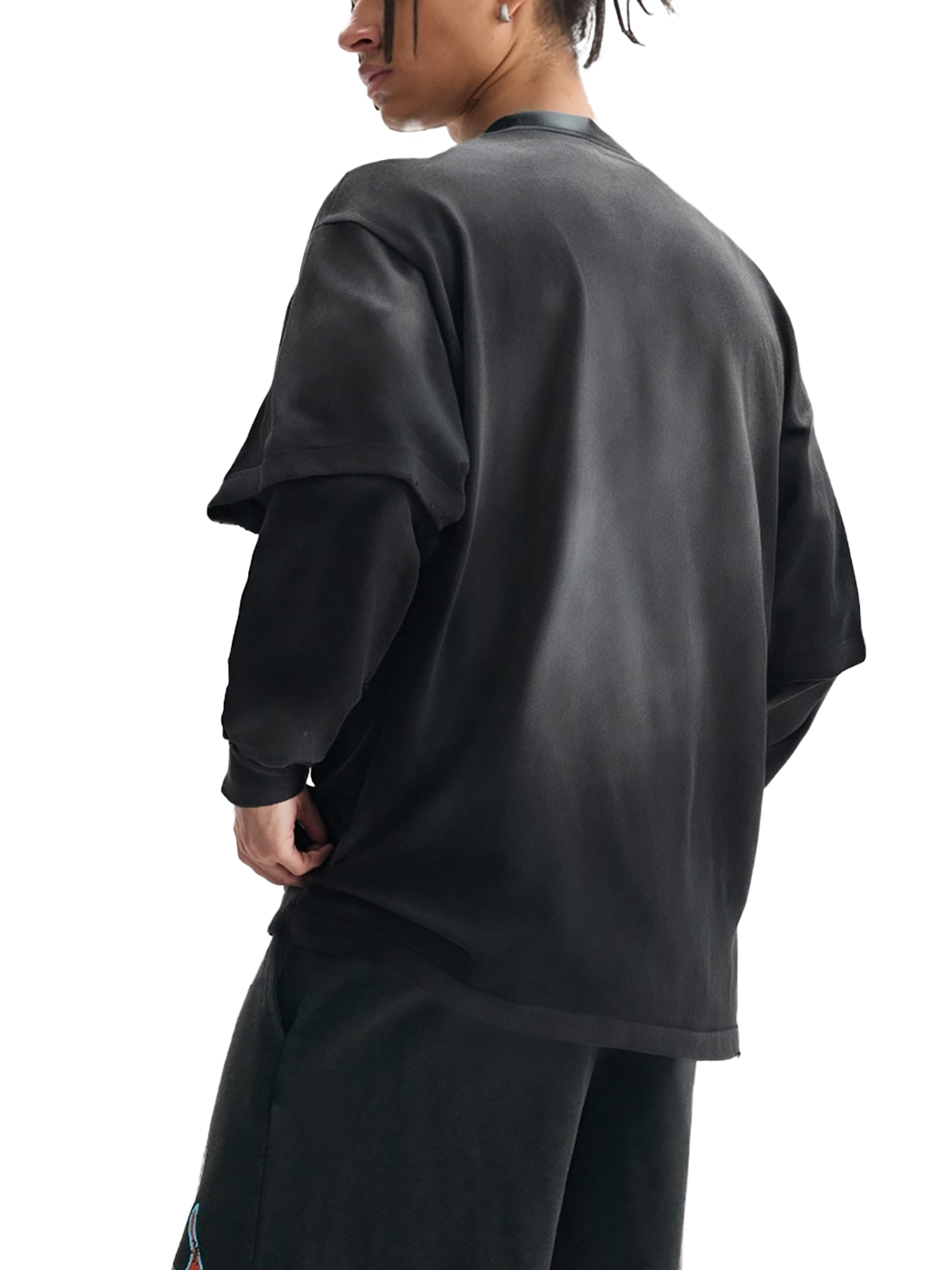 Person wearing a black oversized shirt on a white background
