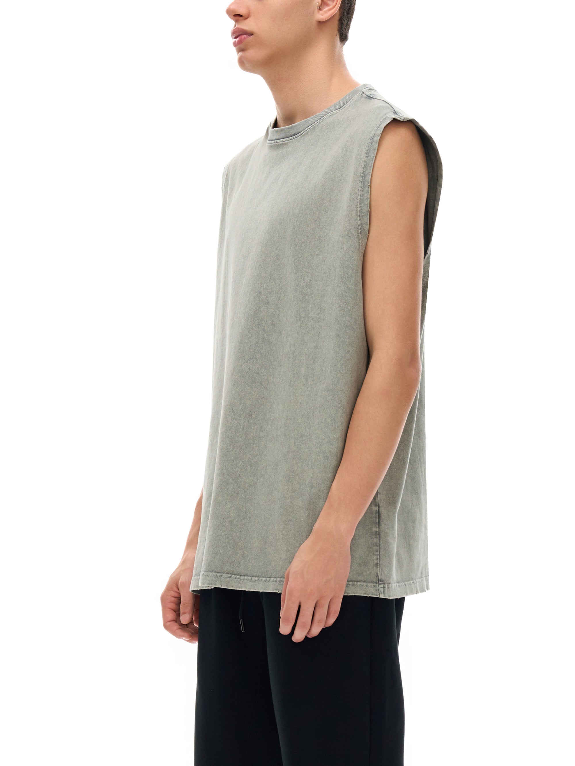 Person wearing a sleeveless green shirt on a white background