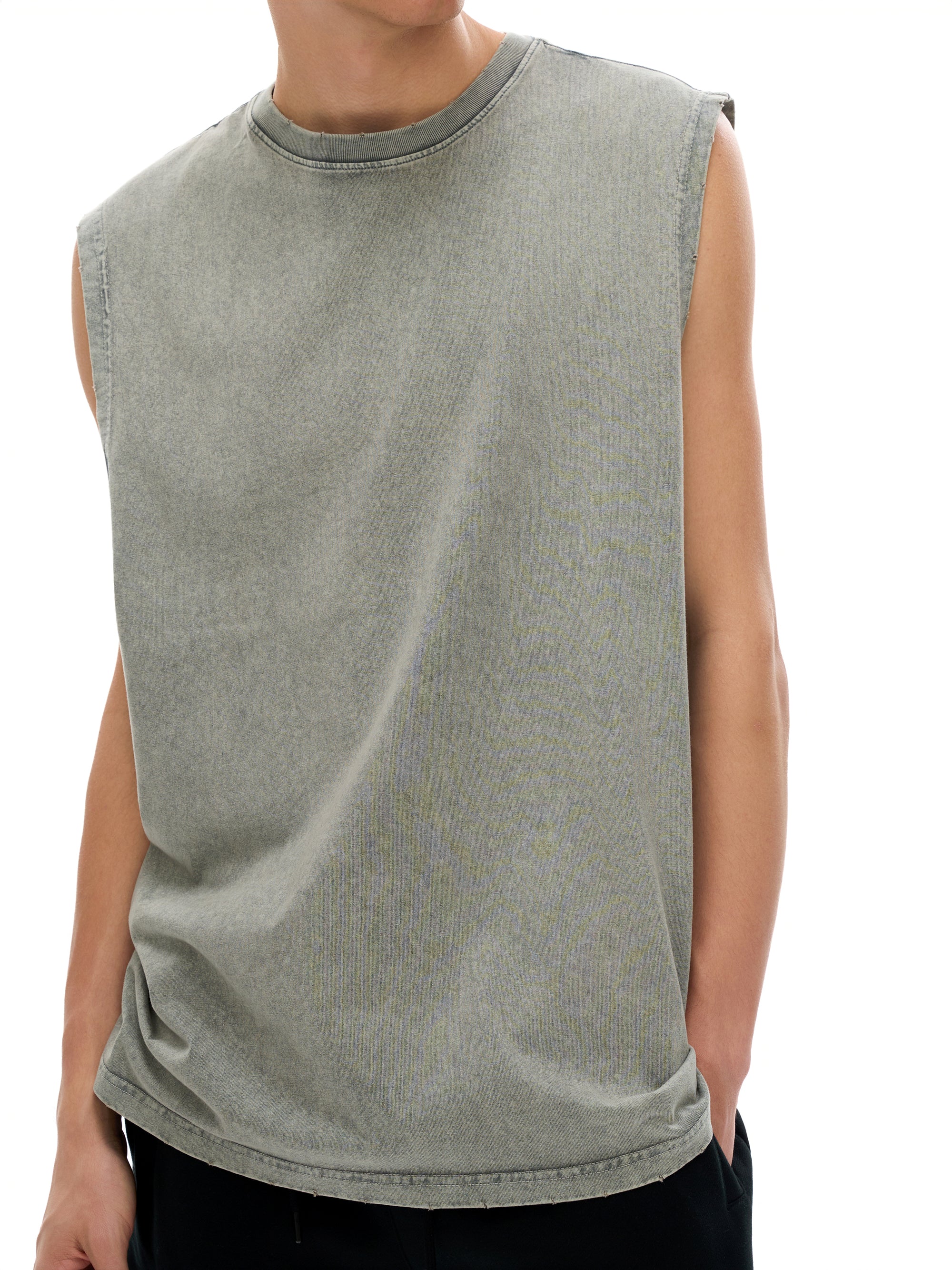 Person wearing a sleeveless green shirt on a white background